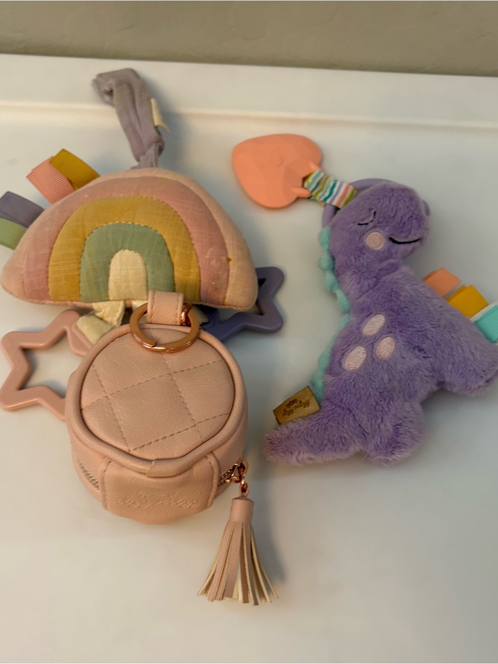 Itzy Ritzy bundle of 2 car seat teether toys and a pink pacifier holder